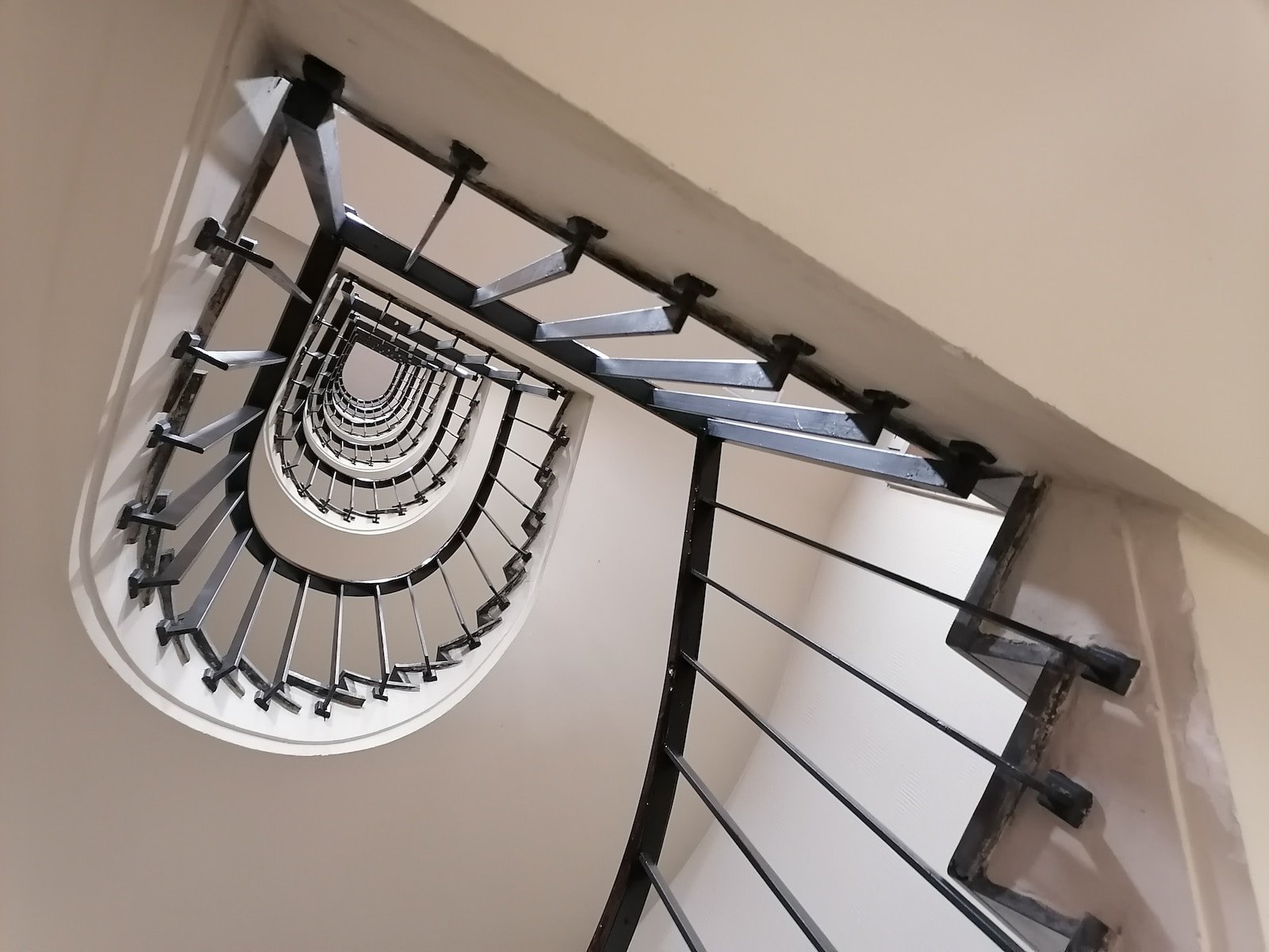 a spiral staircase in a house with a skylight